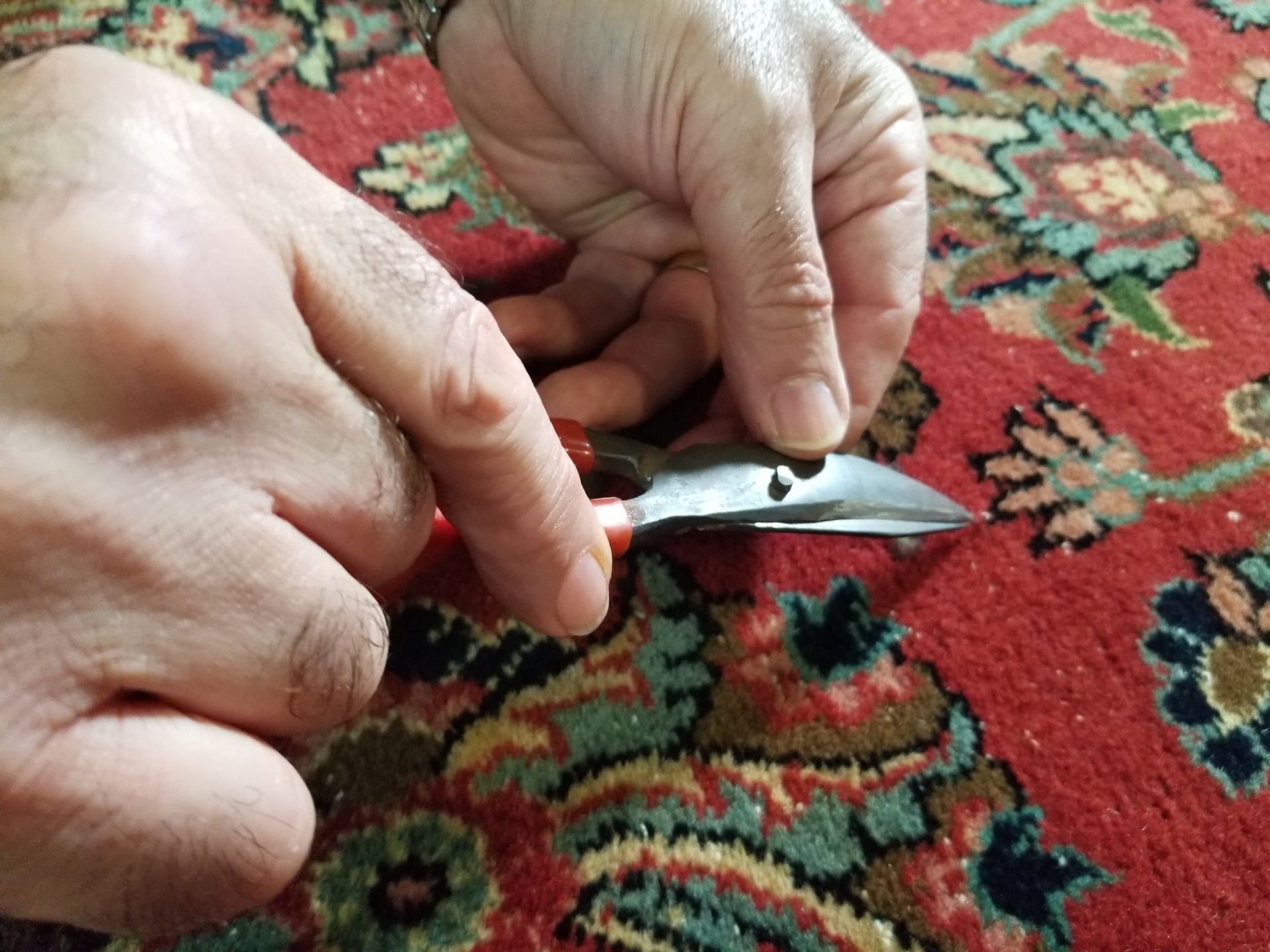 rug repair using small scissors