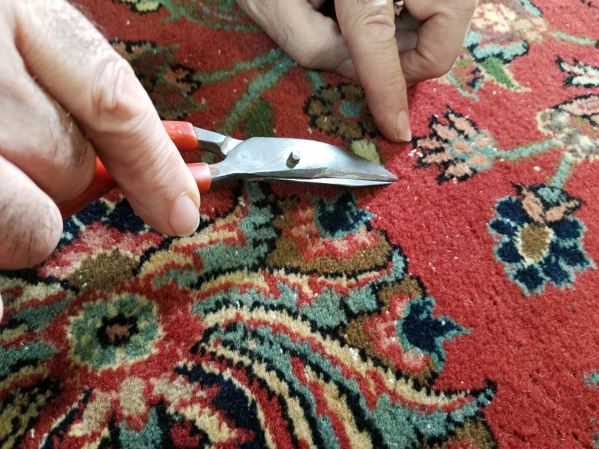 rug repair with small scissors
