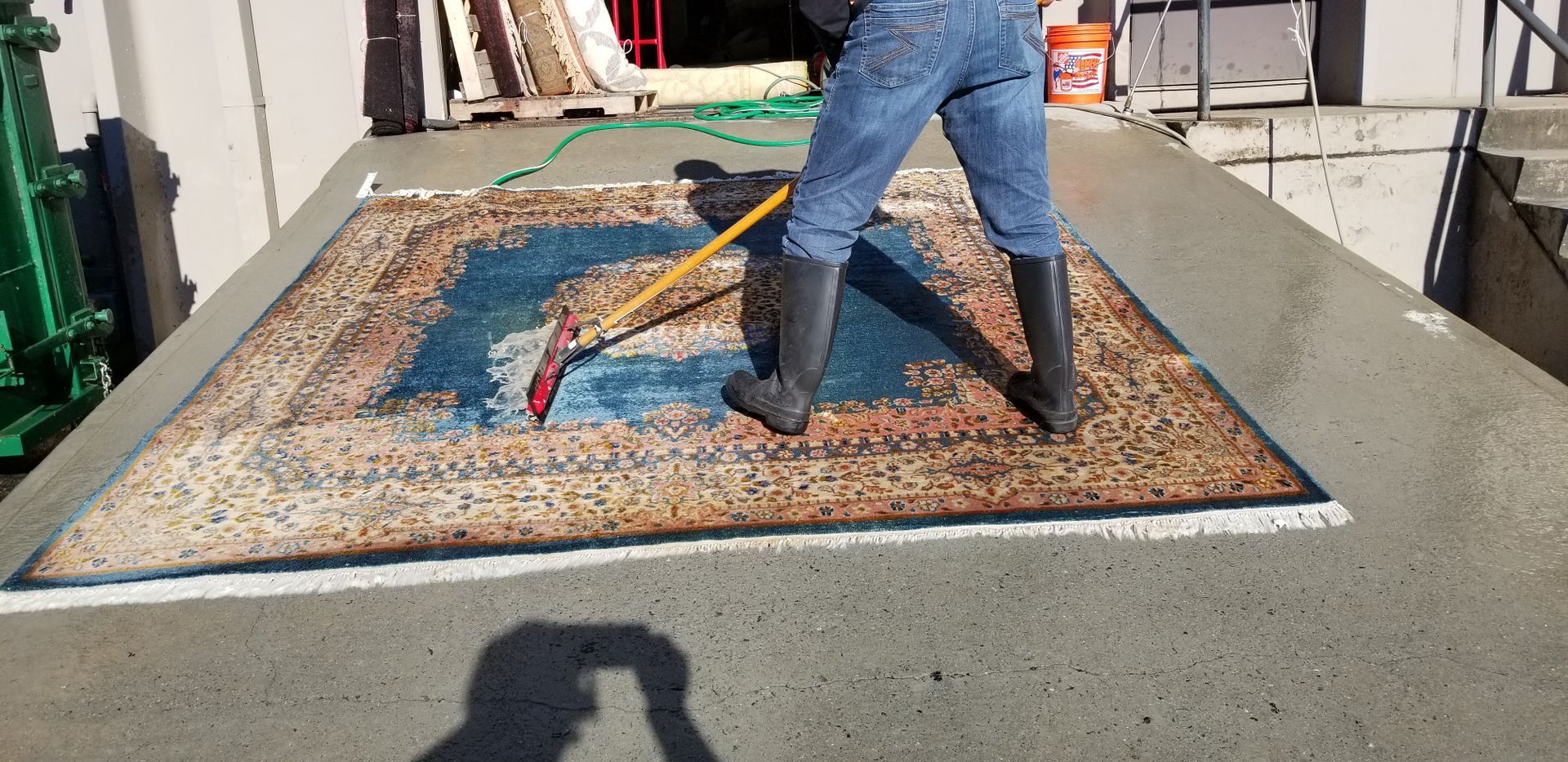 cleaning a blue and brown rug