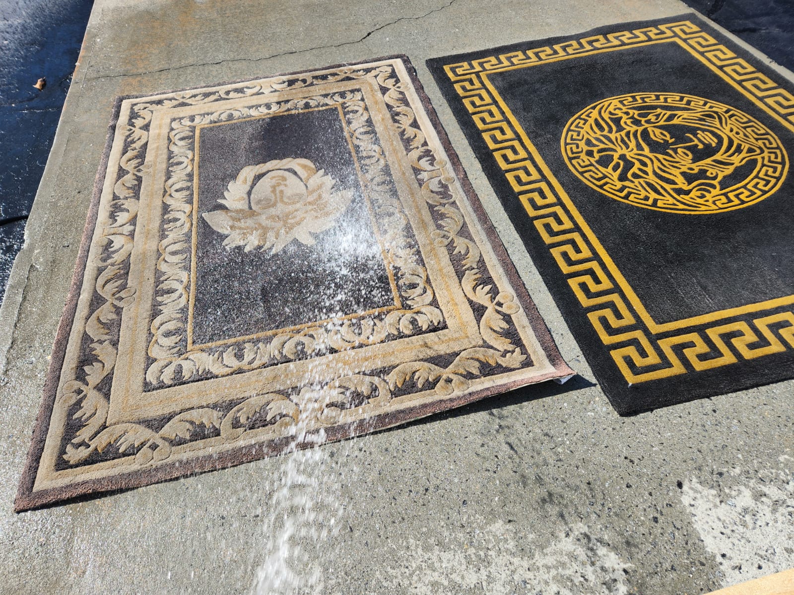 spraying the two rugs with water