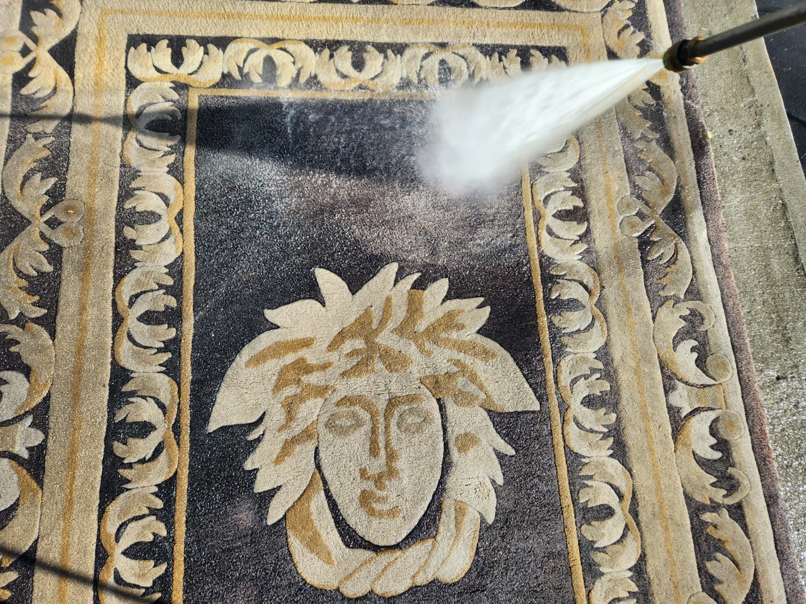 cleaning a rug with a pressure washer