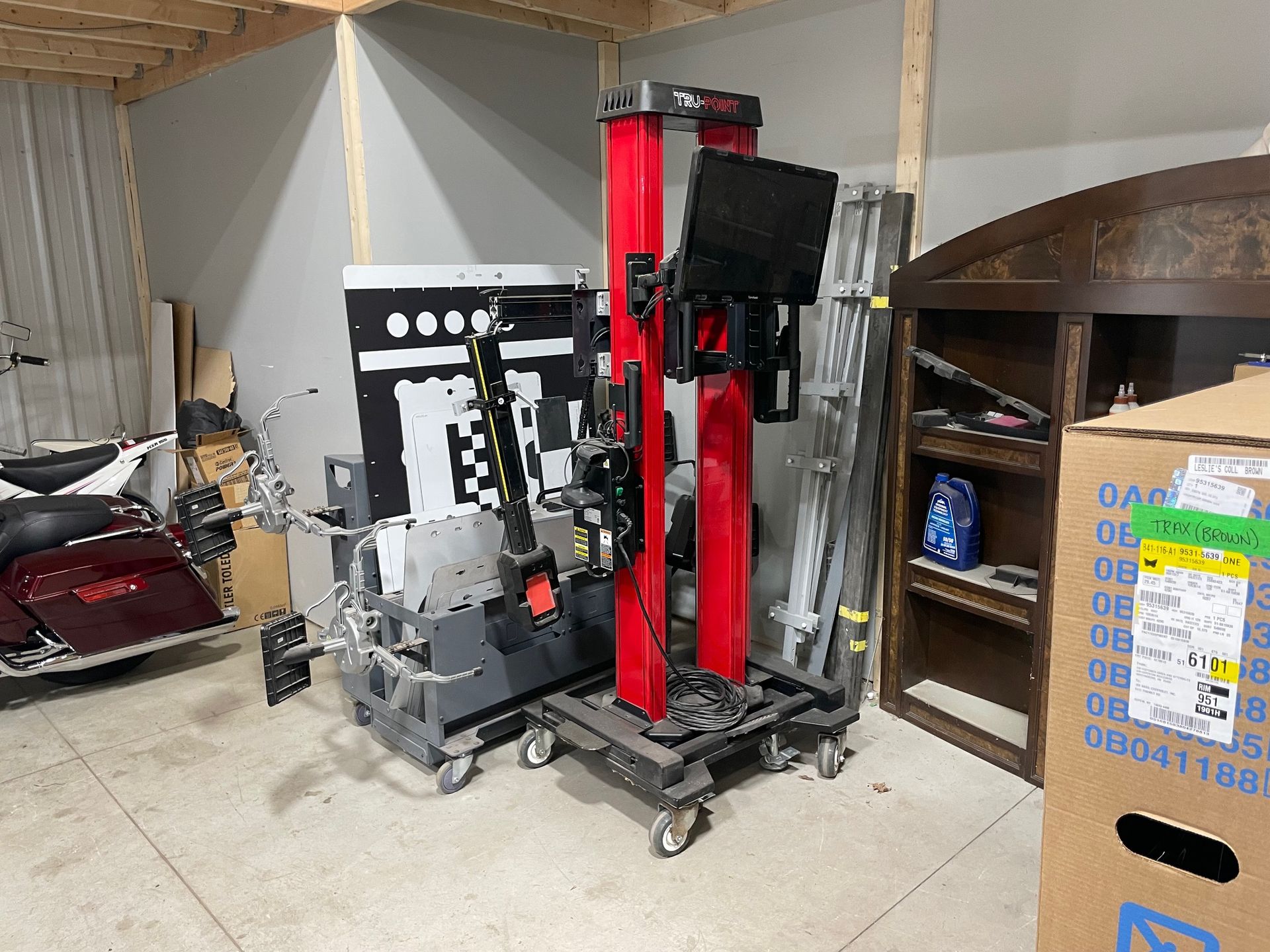 Warehouse storage area with stacked red and black industrial equipment and shelving.