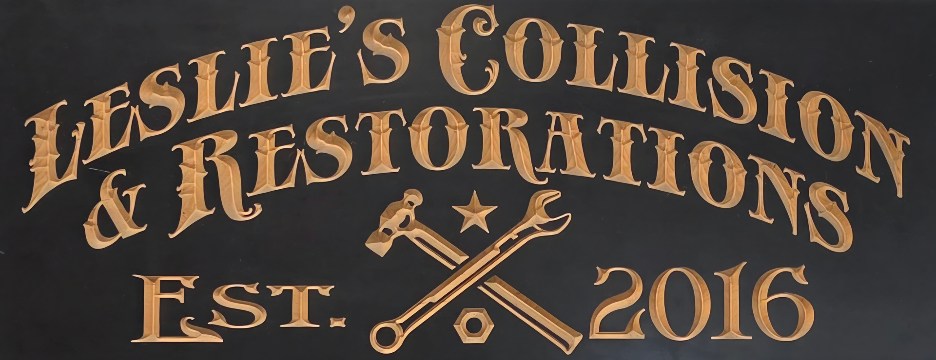 Leslie&rsquo;s Collision & Restoration logo in tan on a dark background, with crossed wrenches and &ldquo;Est. 2016&rdquo;