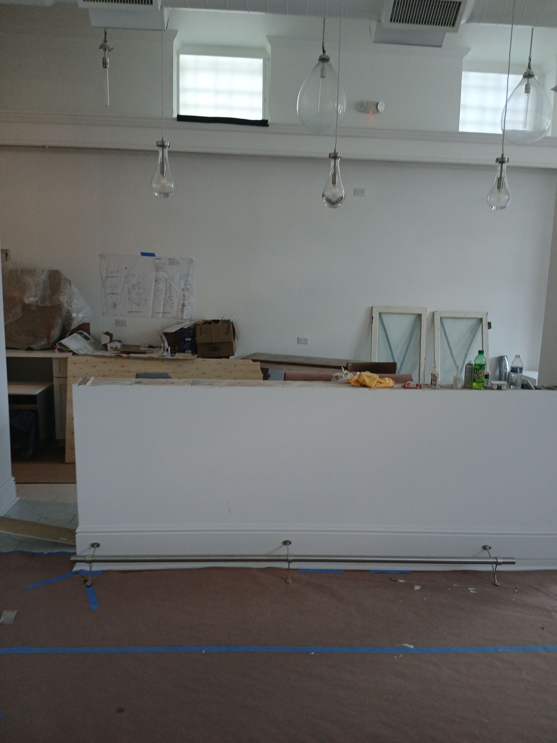 An empty room with a counter in the middle of it.