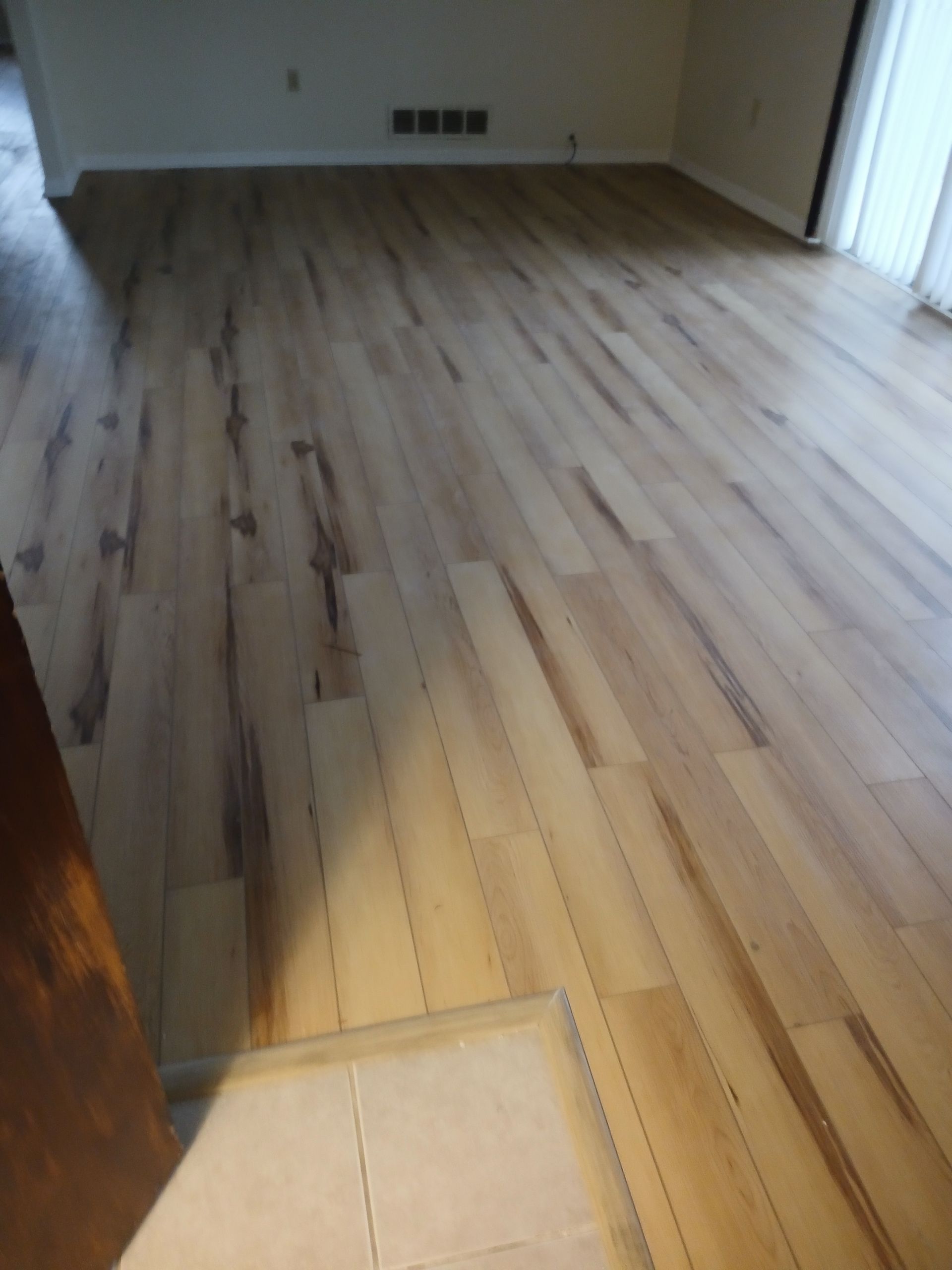 A living room with hardwood floors and a sliding glass door