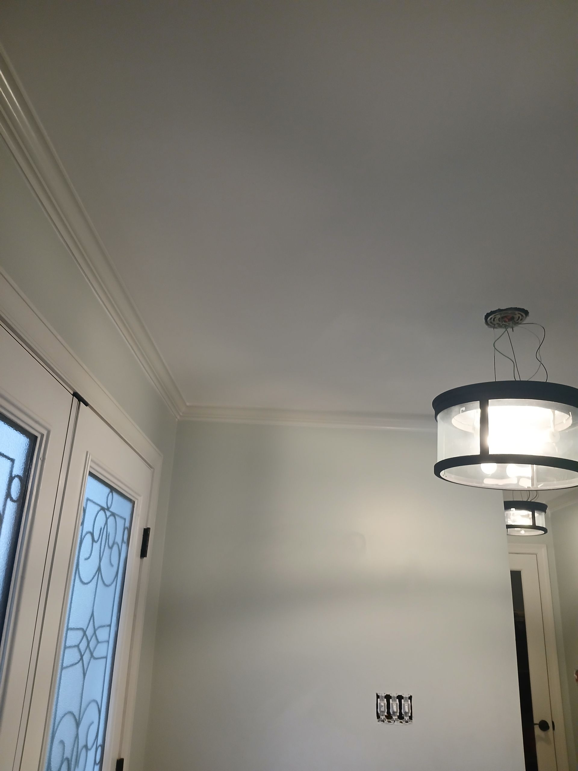 A room with a ceiling light hanging from it