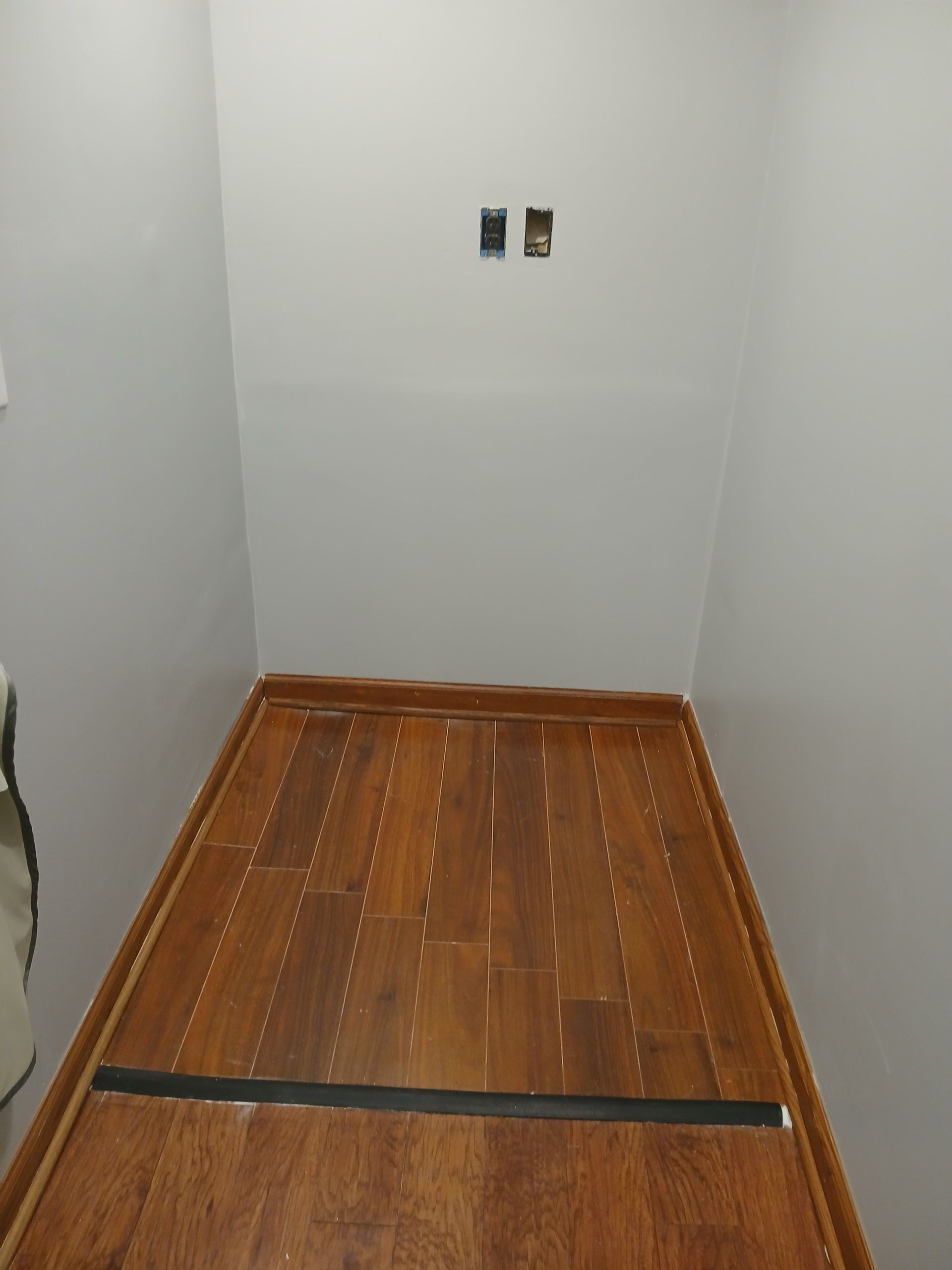 A room with a wooden floor and white walls
