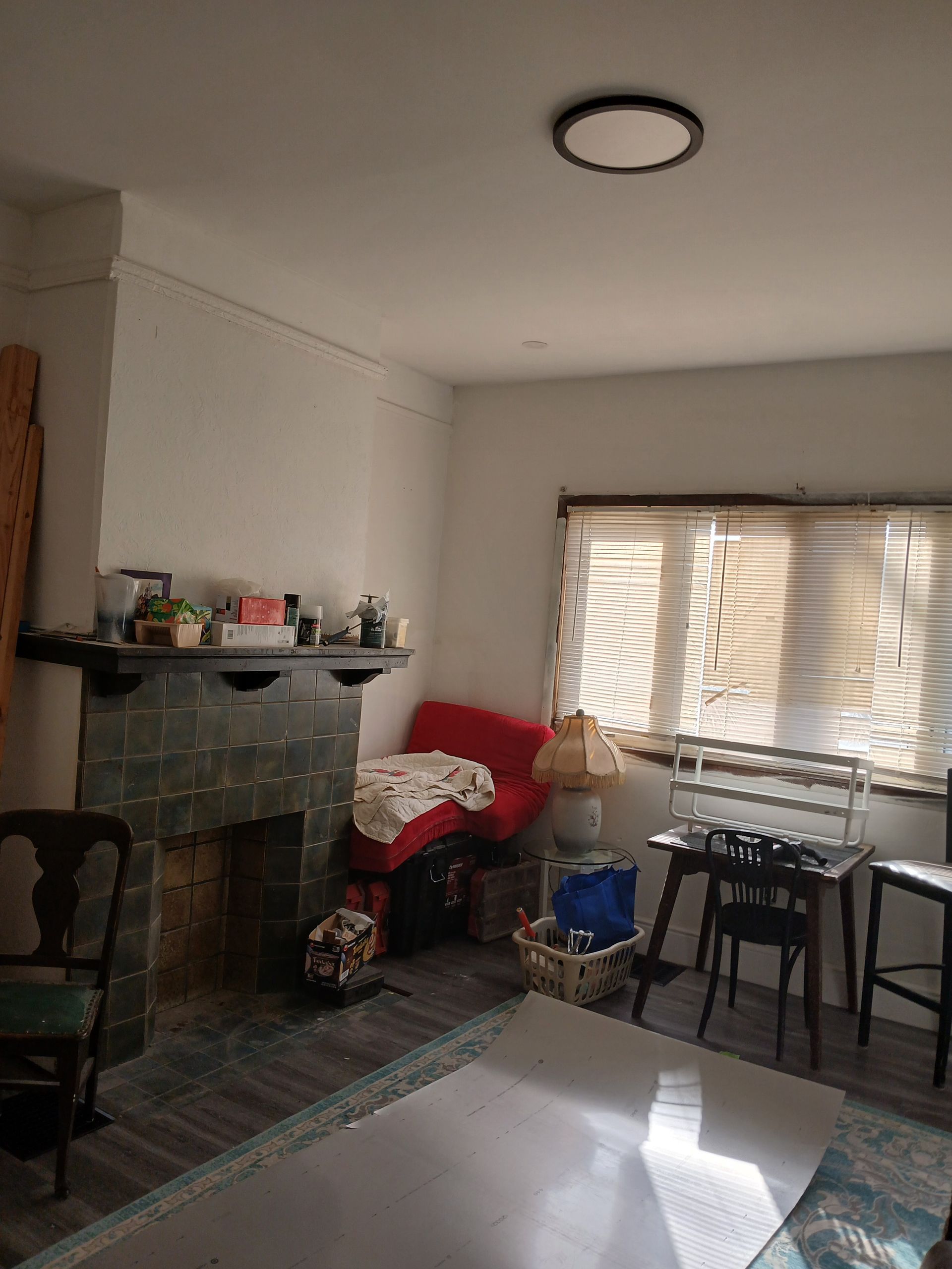 A living room with a fireplace and a red couch