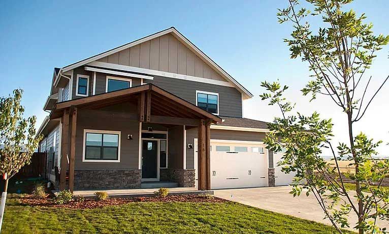 A large house with a lot of windows and a garage