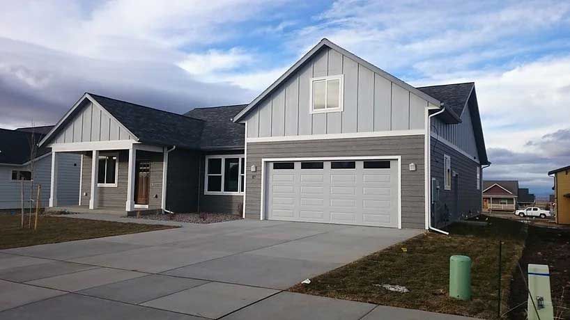 A large house with a garage and a driveway in front of it.
