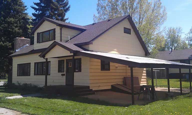 A house with a carport in front of it