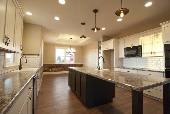 There is a large island in the middle of the kitchen.