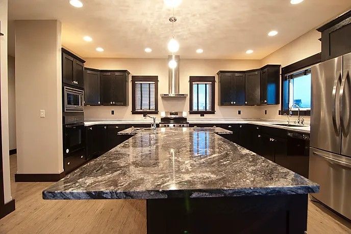 A kitchen with granite counter tops and stainless steel appliances