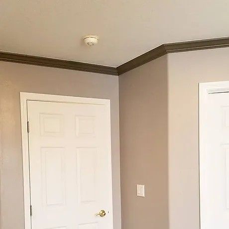 A bedroom with a door and a ceiling light.