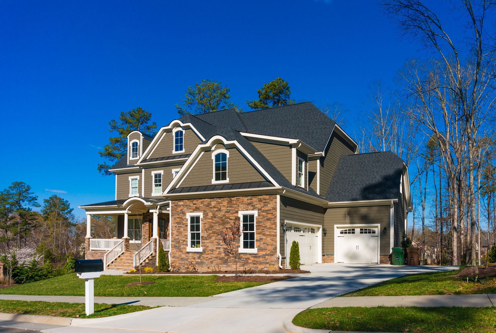 A large house with a mailbox in front of it