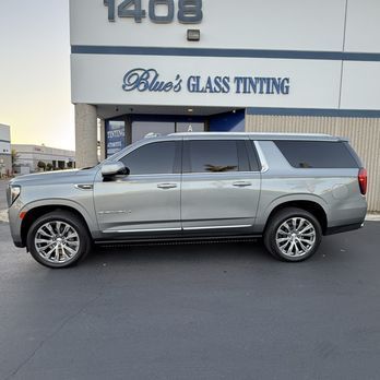Silver SUV parked outside Blue’s Glass Tinting shop