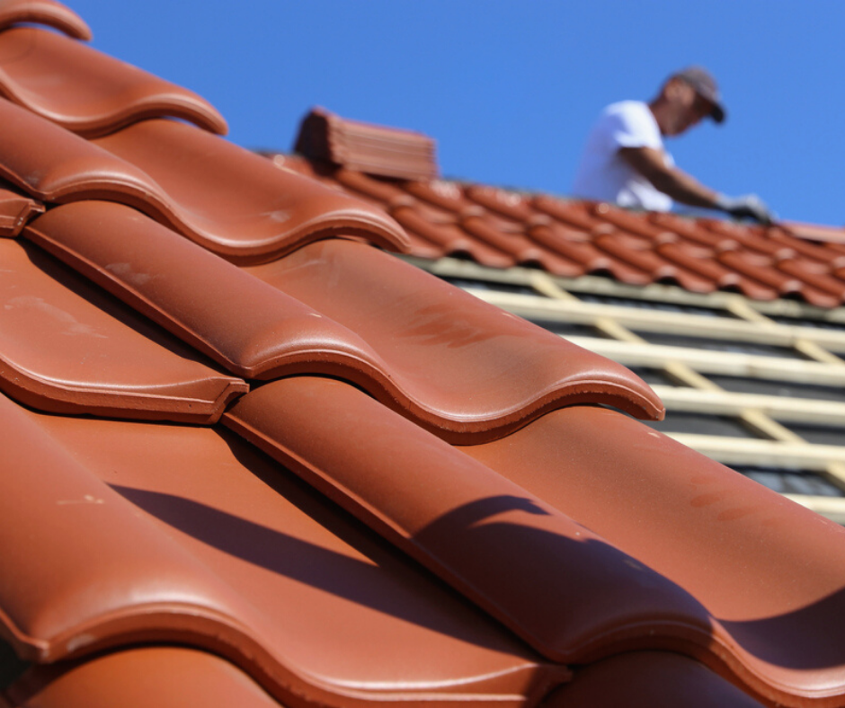 A man is working on the roof of a house