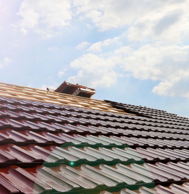 A roof under construction with a blue sky in the background