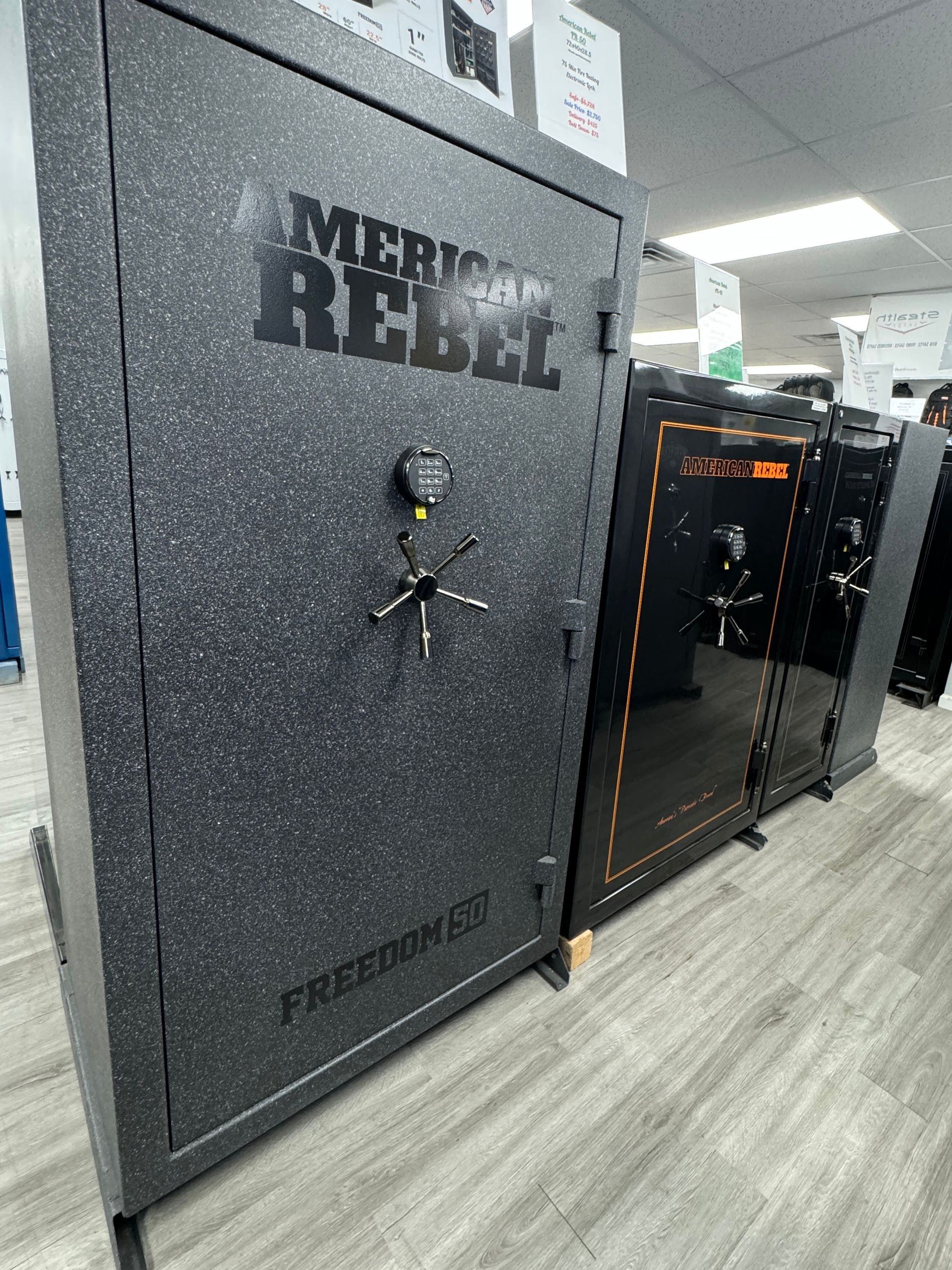 A row of safes are lined up in a room.