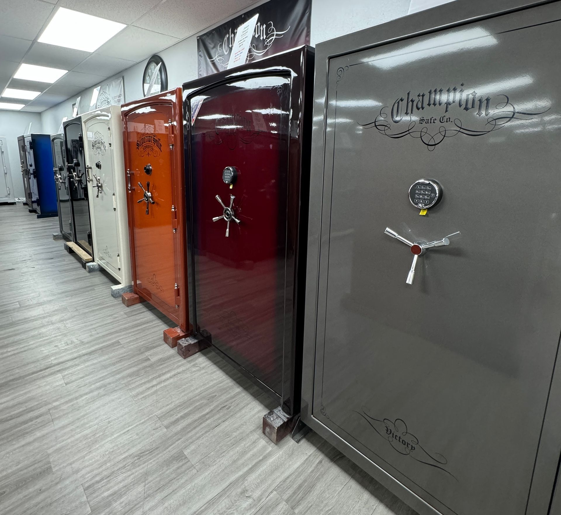 A row of safes are lined up in a room.