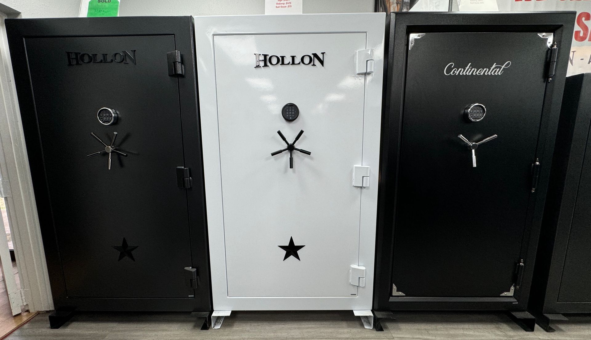 Three safes are lined up next to each other in a room.