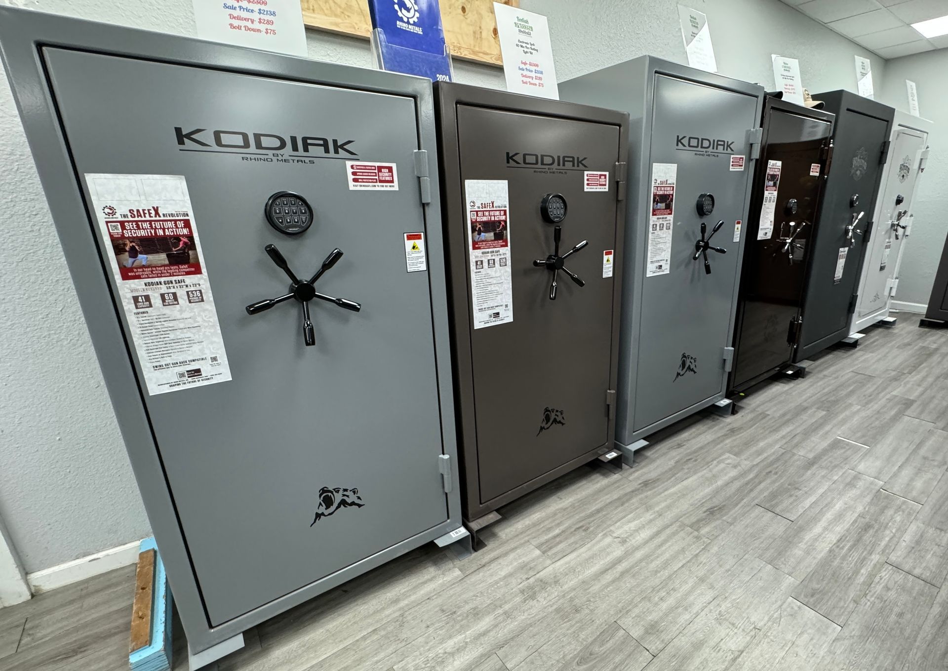 A row of safes are lined up in a room.