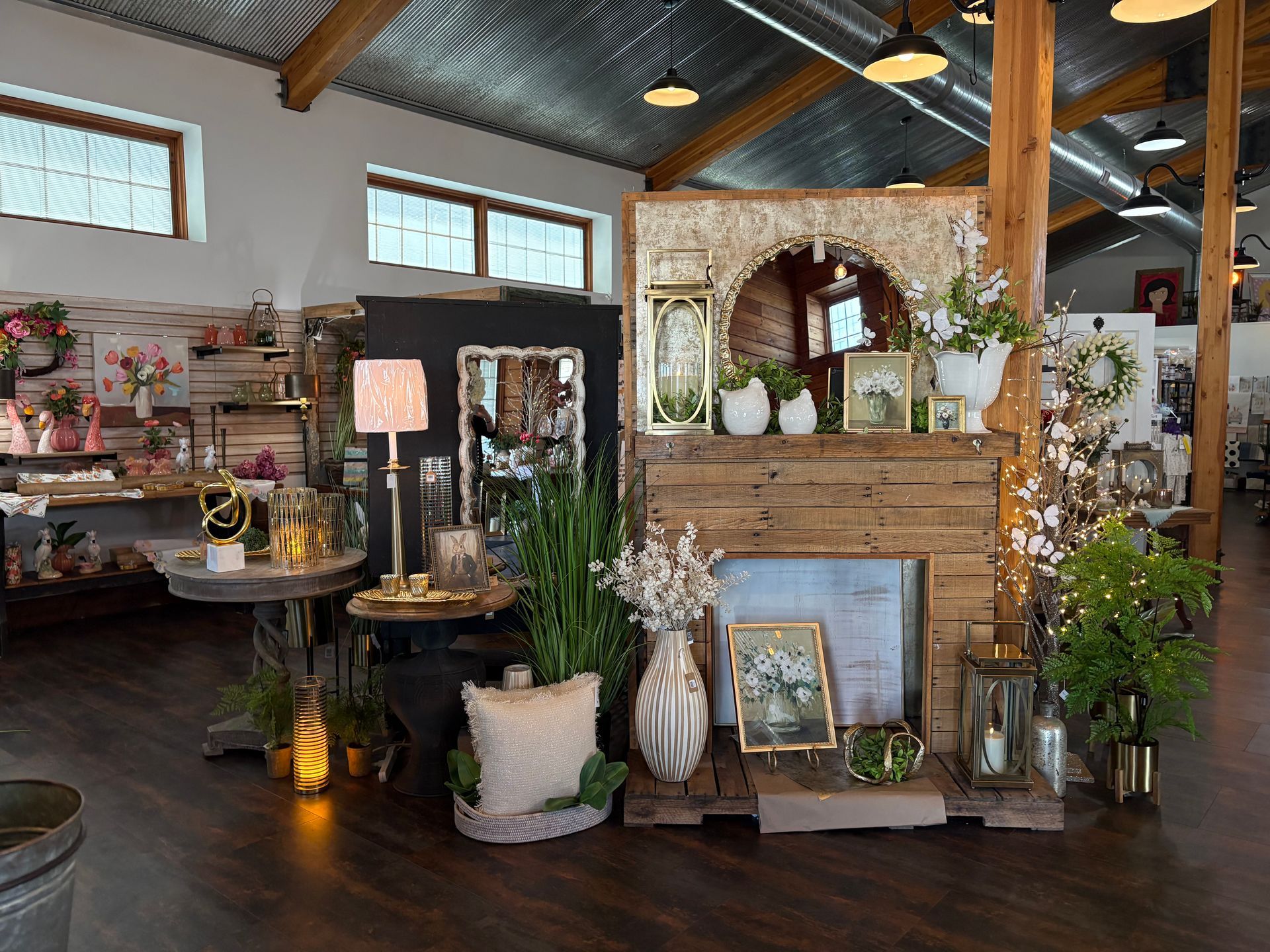 A room filled with lots of potted plants and a fireplace.