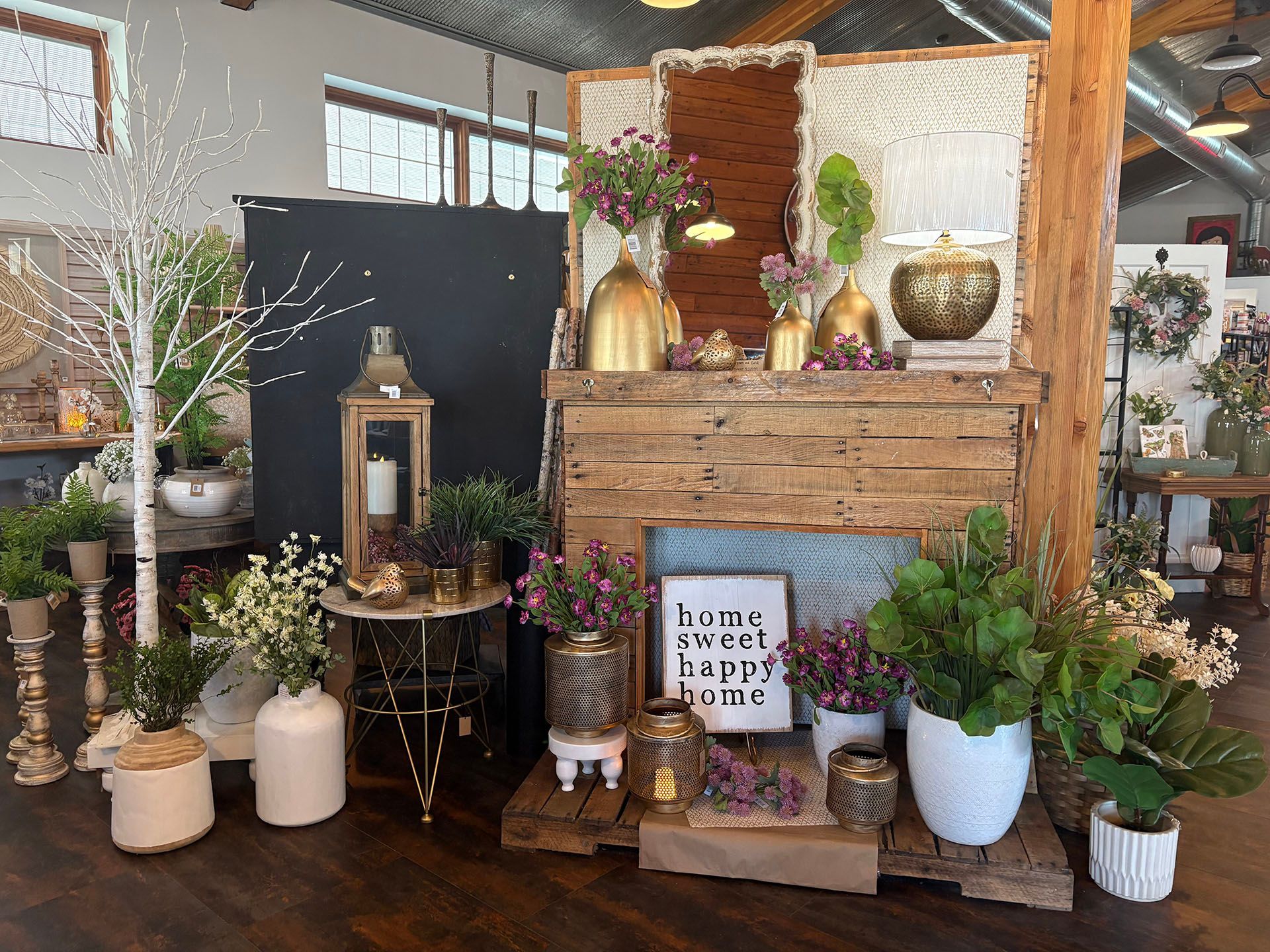 A room filled with lots of potted plants and a fireplace.