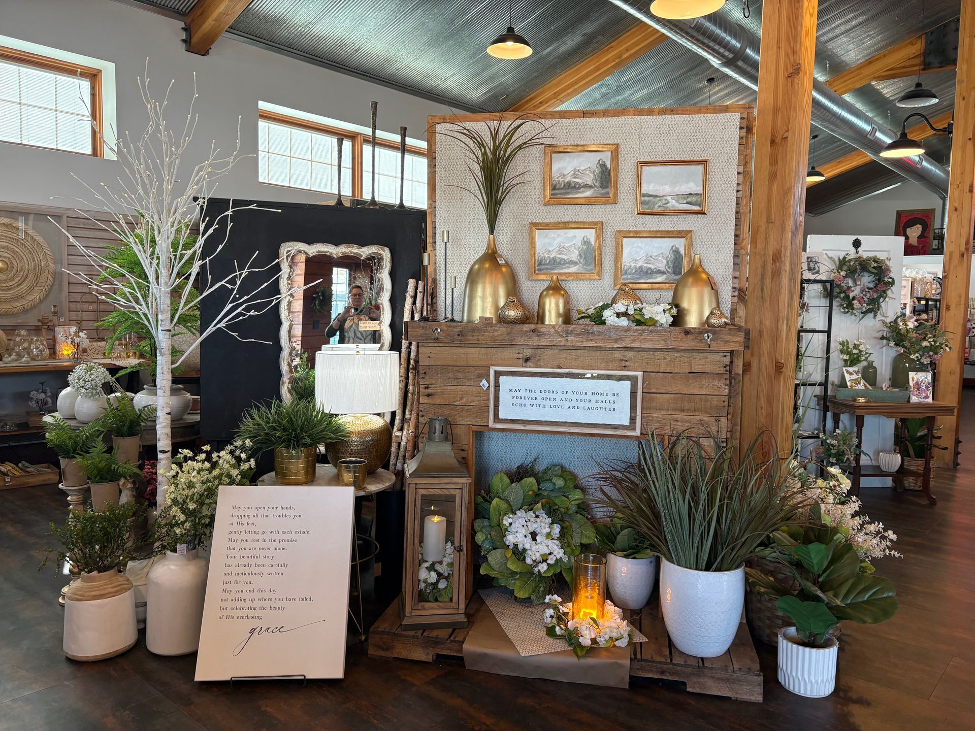 A room filled with lots of potted plants and a fireplace.