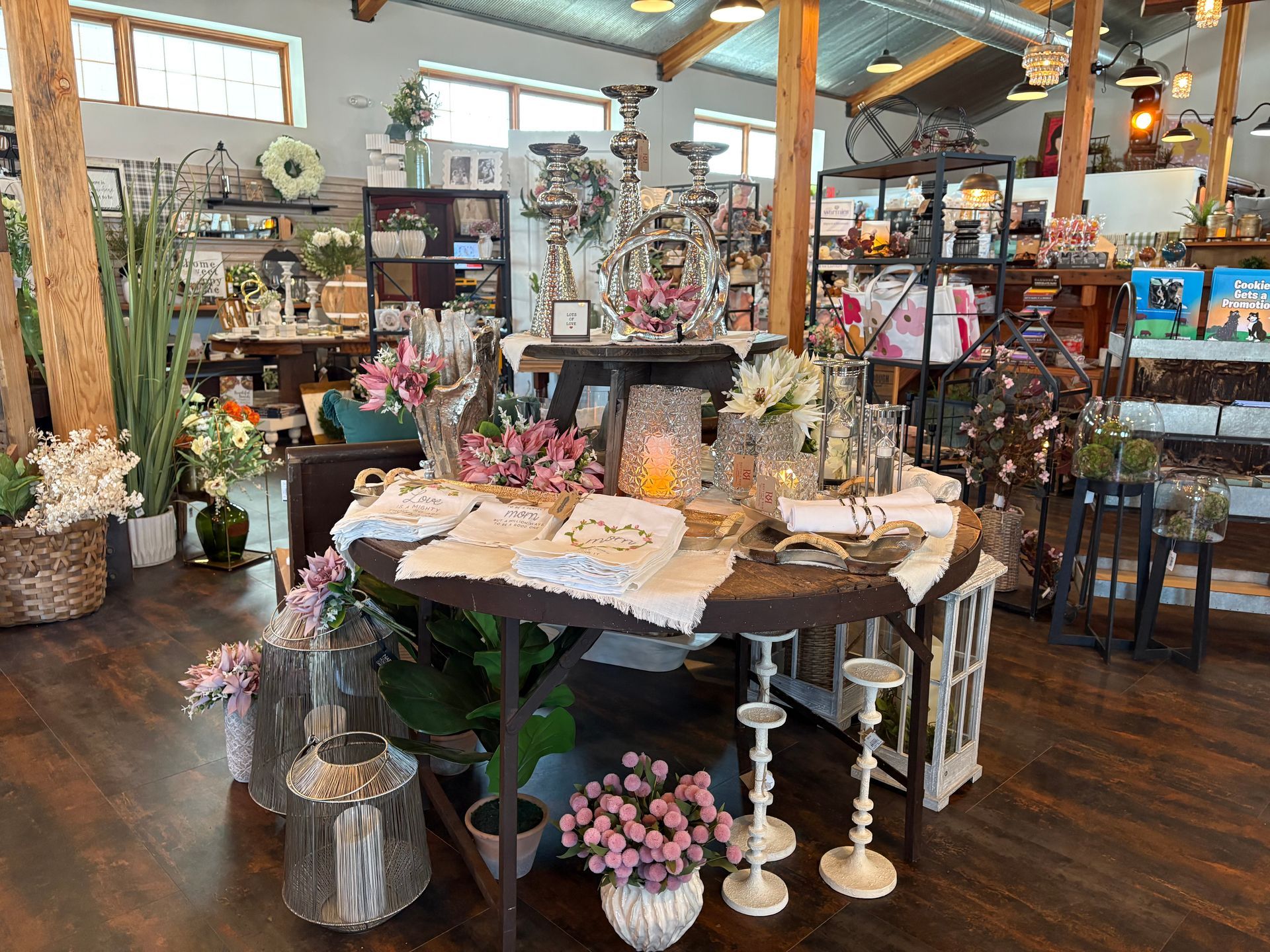 There is a table with flowers on it in the middle of the room.