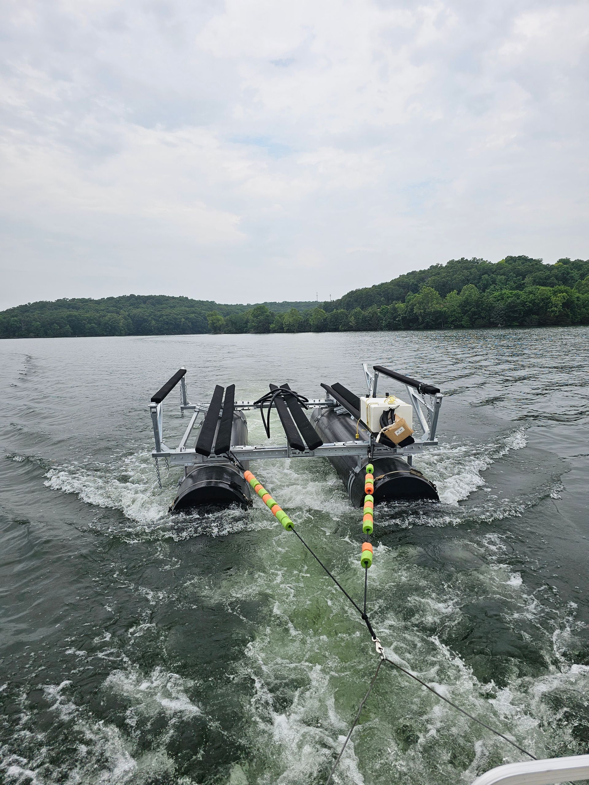A boat is floating on top of a large body of water.