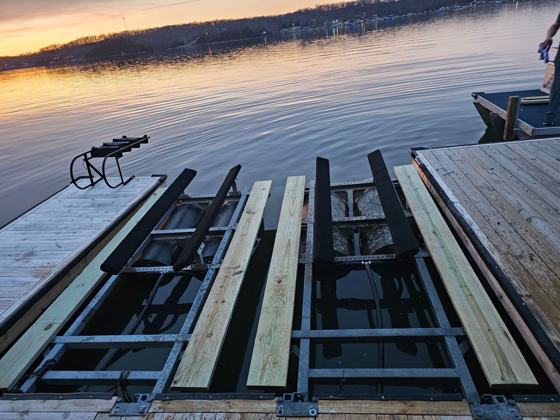 A wooden dock with a ladder going into the water
