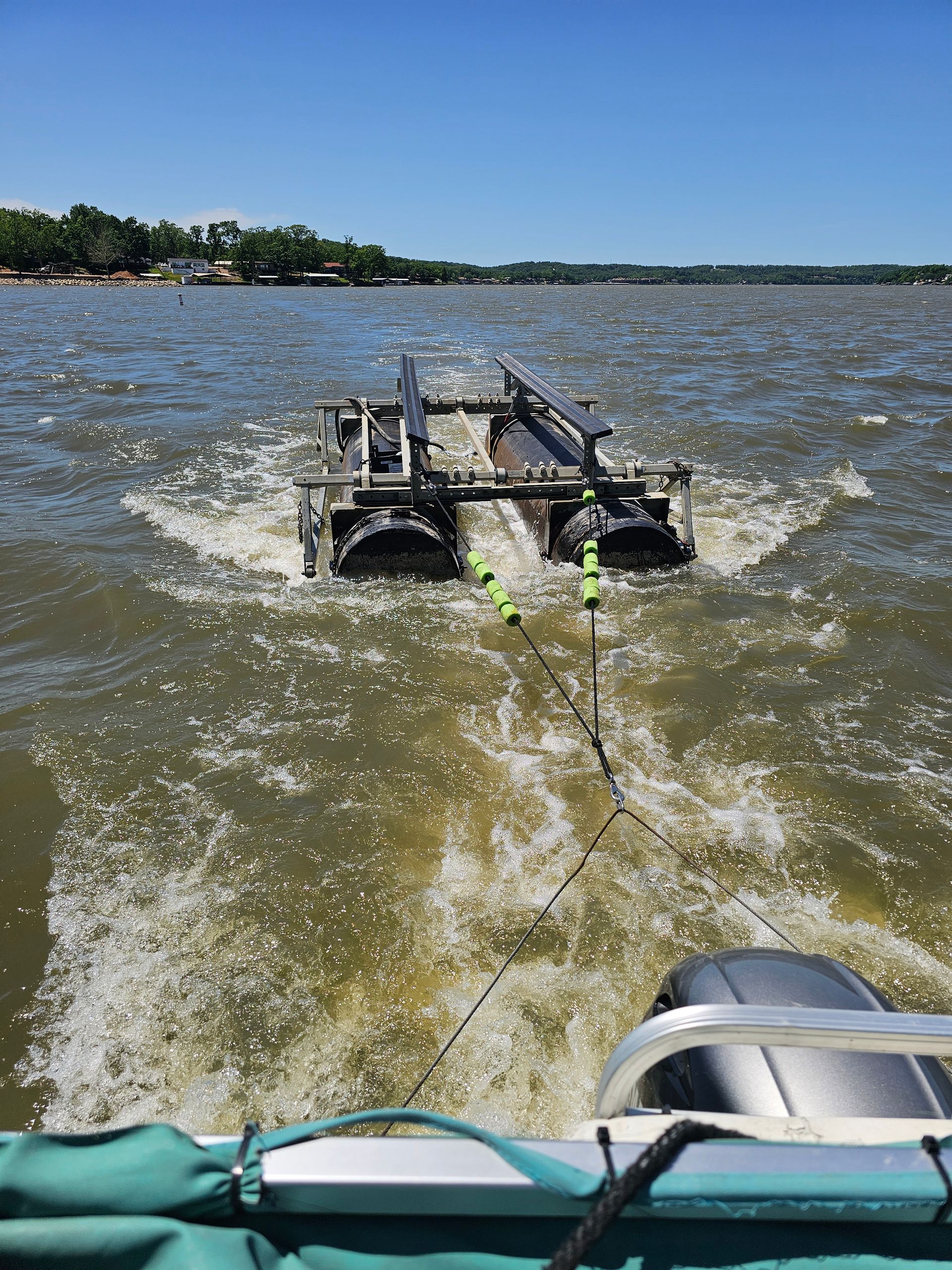A boat is towing a small boat in the water.