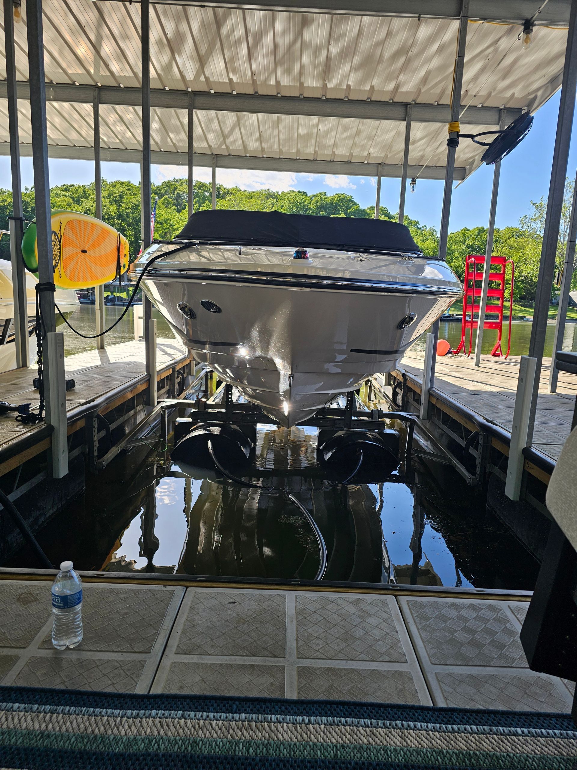 A boat is sitting in a dock next to a body of water.