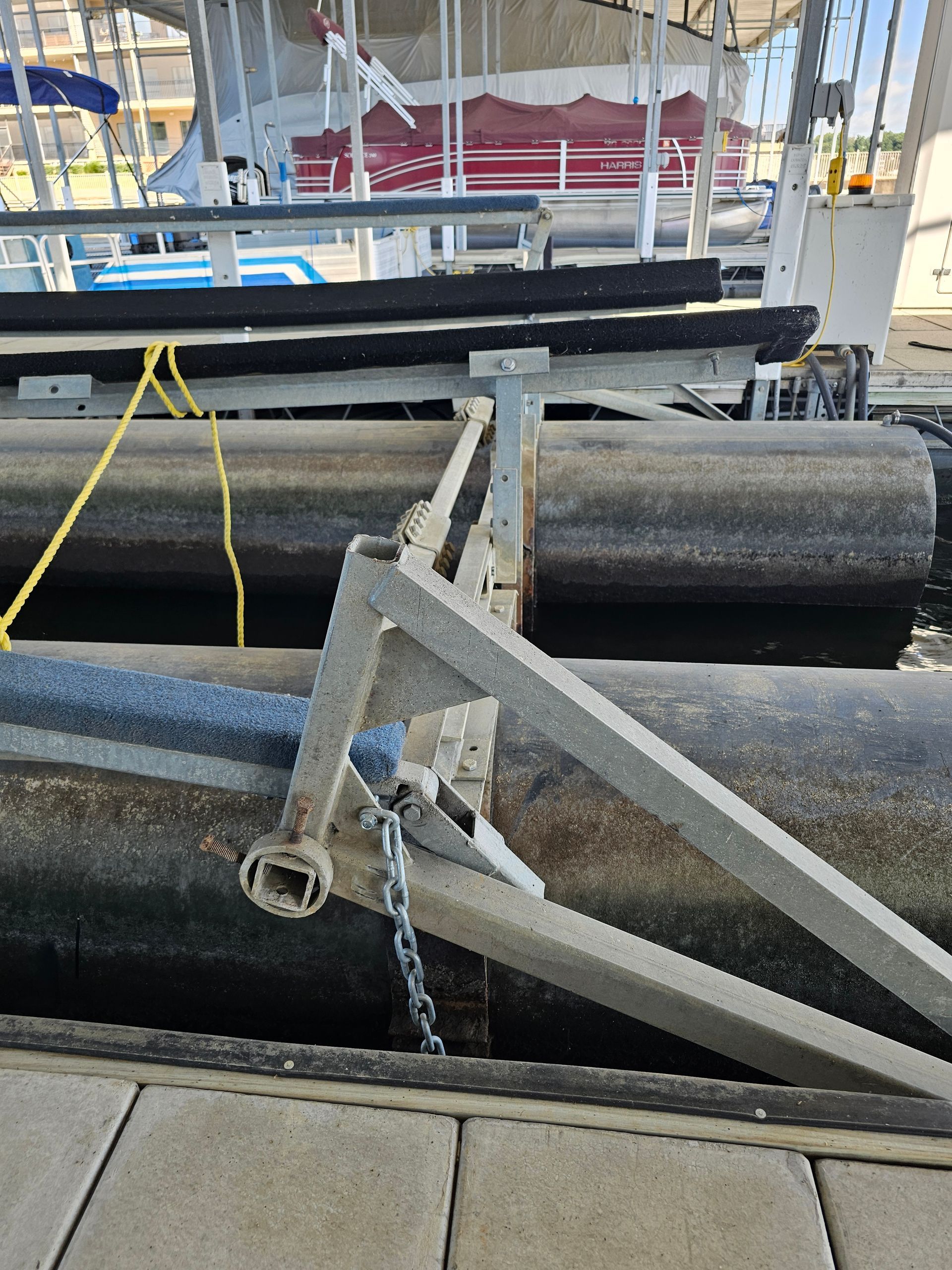 A boat is docked at a dock with a chain attached to it.