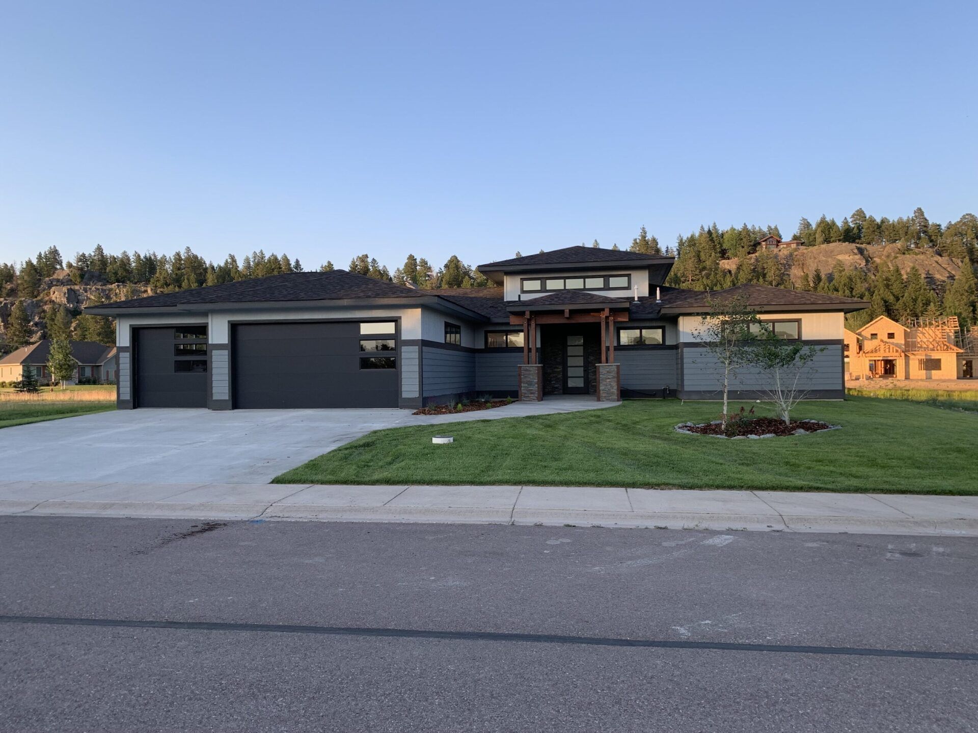 A landscape view of a house with garage doors