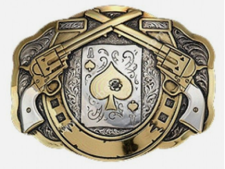 A metallic belt buckle featuring an Ace of Spades playing card surrounded by two crossed gold revolvers and ornate filigree.