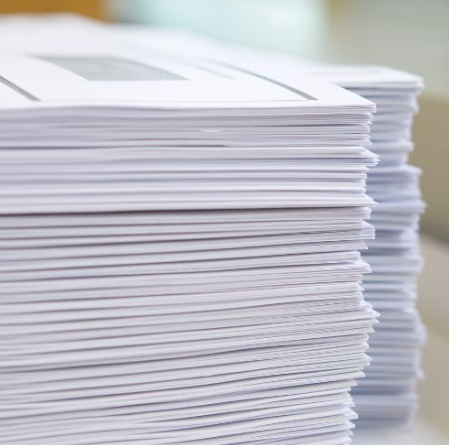 Stack of white paper sheets neatly piled in a close-up view