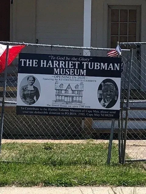 Sign for The Harriet Tubman Museum, Cape May, NJ, with portraits and the museum's name.