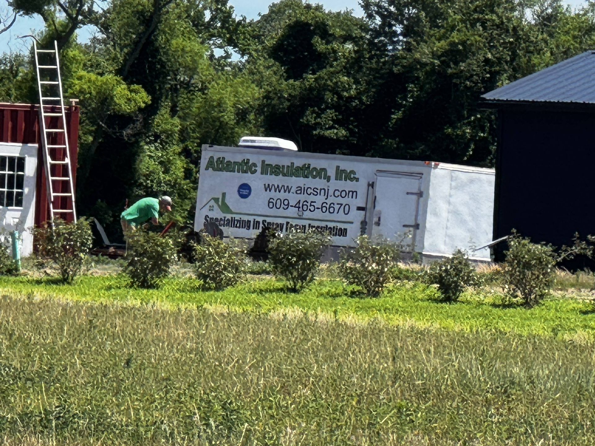 Sign for Ablade Innovation, Inc. beside a white truck and red ladder in a grassy yard