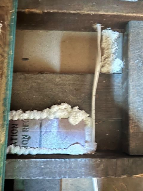 Open box with white foam packing and a small labeled item inside, viewed from above.