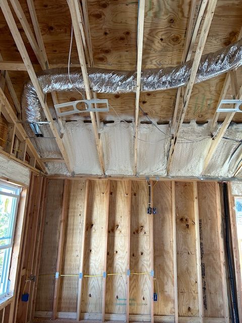 Unfinished room with exposed wood framing, insulation, and HVAC ductwork in the ceiling