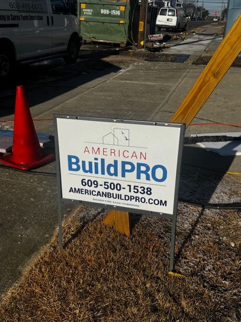 American Build Pro yard sign beside orange cone on a construction site