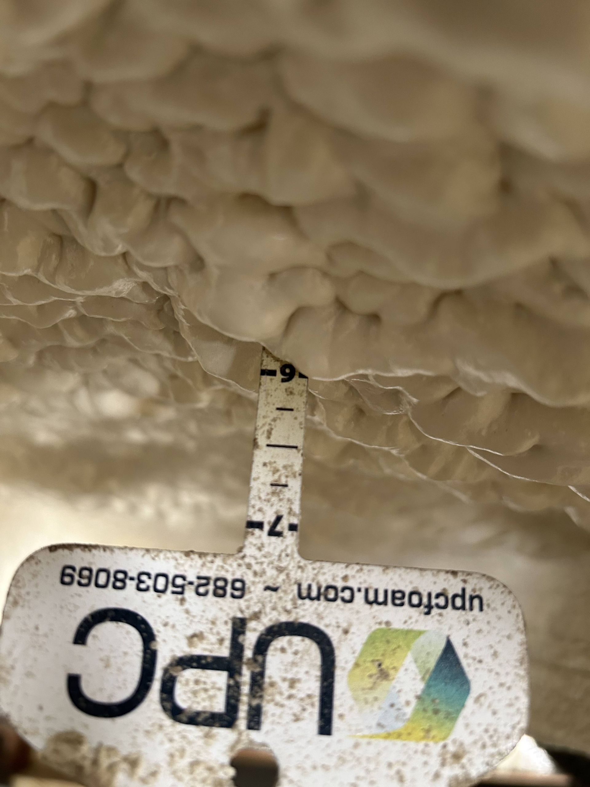 UPC label with a vertical black-and-white calibration scale on a beige textured surface.