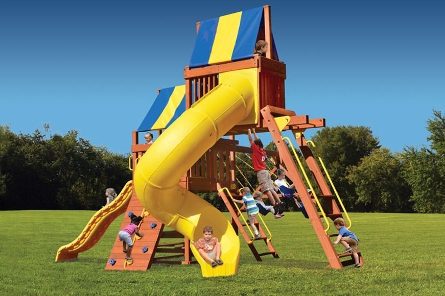 A group of children are playing on a playground with a yellow slide.