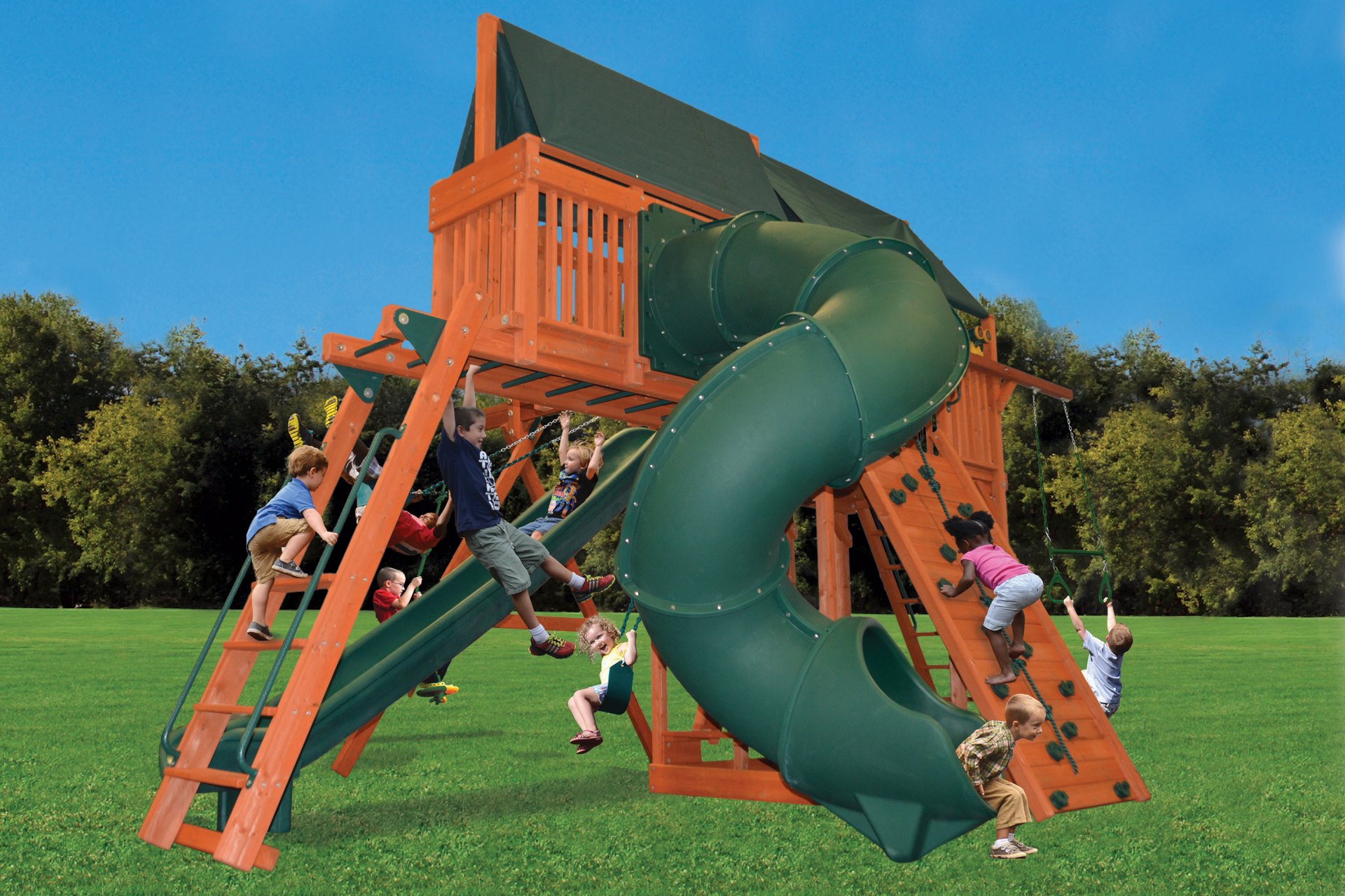 A group of children are playing on a wooden playground set with a green slide.