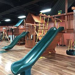 A playground with slides , swings , and a tire swing.