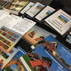 A bunch of brochures are sitting on top of each other on a table.