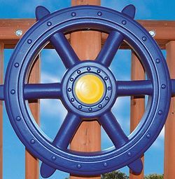 A blue steering wheel is hanging on a wooden fence.