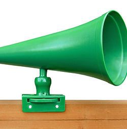 A green megaphone is sitting on top of a wooden table.